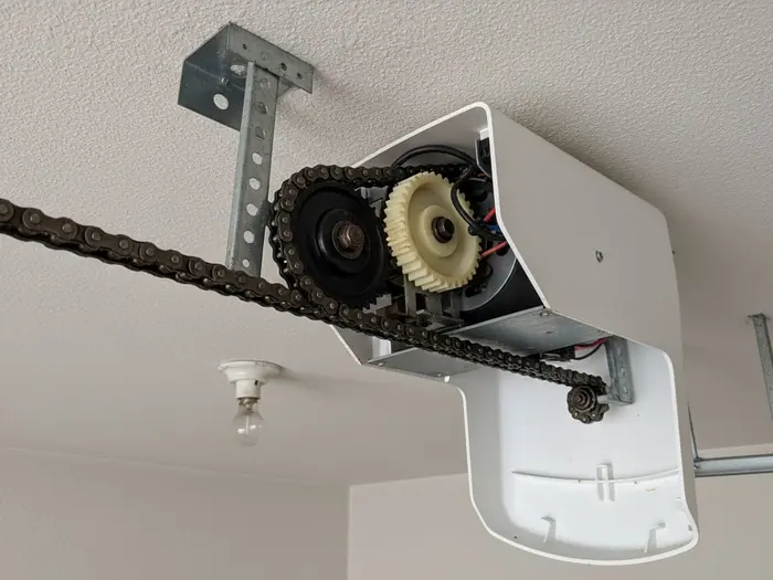 An open chain-drive opener head with the gear housing exposed